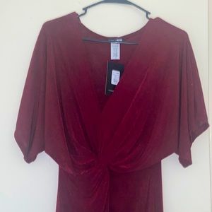 This is a burgundy knee length size L from fashion nova with a slit in the front